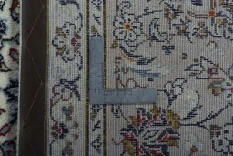 Backside of handmade 2000s Kashan rug showing knot structure and weave density