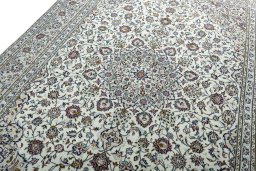 Backside of handmade 2000s Kashan rug showing knot structure and weave density