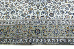 Corner detail of 2000s Kashan rug showing border pattern and Wool pile