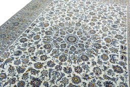 Backside of handmade 2000s Kashan rug showing knot structure and weave density