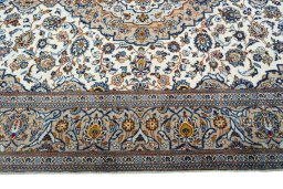 Corner detail of 2000s Kashan rug showing border pattern and Wool pile