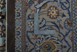 Backside of handmade 2000s Kashan rug showing knot structure and weave density