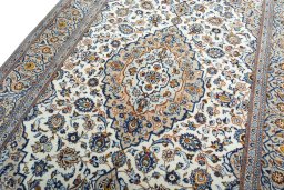 Backside of handmade 2000s Kashan rug showing knot structure and weave density