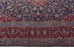 Corner detail of 2000s Kashan rug showing border pattern and Cork pile