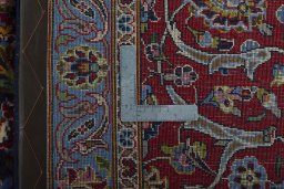 Backside of handmade 2000s Kashan rug showing knot structure and weave density