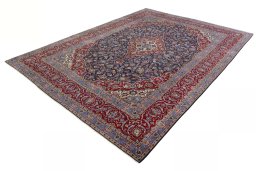 Corner detail of 2000s Kashan rug showing border pattern and Cork pile