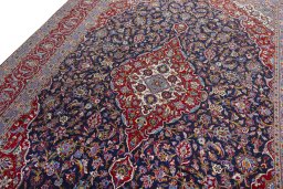 Backside of handmade 2000s Kashan rug showing knot structure and weave density