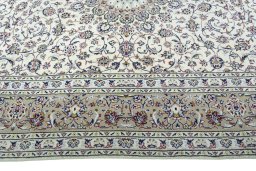 Corner detail of 2000s Kashan rug showing border pattern and Wool pile