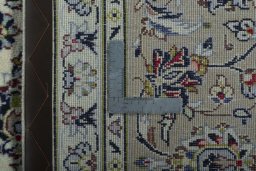 Backside of handmade 2000s Kashan rug showing knot structure and weave density