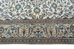 Corner detail of 2000s Kashan rug showing border pattern and Wool pile