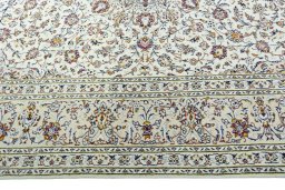 Corner detail of 2000s Kashan rug showing border pattern and Wool pile