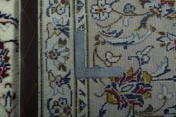 Backside of handmade 2000s Kashan rug showing knot structure and weave density