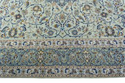 Corner detail of 2000s Kashan rug showing border pattern and Wool pile