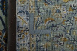 Backside of handmade 2000s Kashan rug showing knot structure and weave density