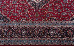 Corner detail of 2000s Kashan rug showing border pattern and Wool pile