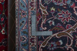 Backside of handmade 2000s Kashan rug showing knot structure and weave density
