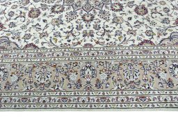 Corner detail of 2000s Kashan rug showing border pattern and Wool pile