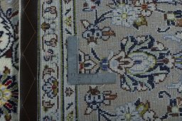 Backside of handmade 2000s Kashan rug showing knot structure and weave density