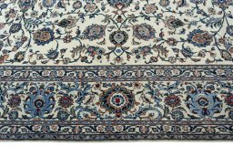 Corner detail of 2000s Kashan rug showing border pattern and Wool pile