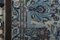 Backside of handmade 2000s Kashan rug showing knot structure and weave density