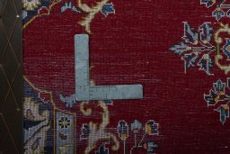 Backside of handmade New Kashan rug showing knot structure and weave density