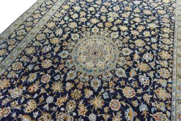 Backside of handmade 2000s Kashan rug showing knot structure and weave density