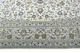 Corner detail of 2000s Kashan rug showing border pattern and Wool pile