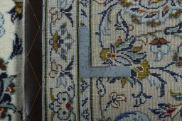 Backside of handmade 2000s Kashan rug showing knot structure and weave density