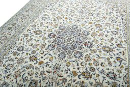 Backside of handmade 2000s Kashan rug showing knot structure and weave density