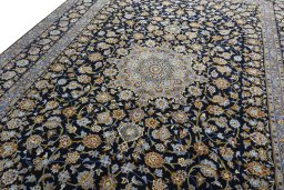 Backside of handmade 2000s Kashan rug showing knot structure and weave density