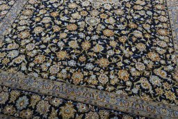 Close-up detail of 2000s Kashan rug from Iran / Persia showing Wool weave
