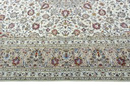 Corner detail of 2000s Kashan rug showing border pattern and Wool pile