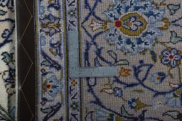 Backside of handmade 2000s Kashan rug showing knot structure and weave density