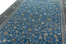 Backside of handmade 2000s Kashan rug showing knot structure and weave density