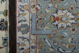 Backside of handmade 2000s Kashan rug showing knot structure and weave density