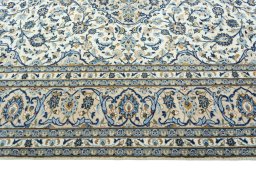 Corner detail of 2000s Kashan rug showing border pattern and Wool pile