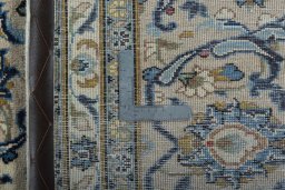 Backside of handmade 2000s Kashan rug showing knot structure and weave density
