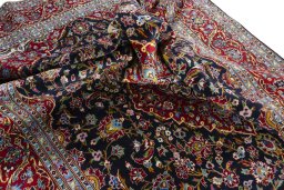Backside of handmade 2000s Kashan rug showing knot structure and weave density