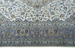 Corner detail of 2000s Kashan rug showing border pattern and Cork pile