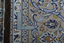 Backside of handmade 2000s Kashan rug showing knot structure and weave density