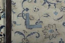Backside of handmade 2000s Kashan rug showing knot structure and weave density