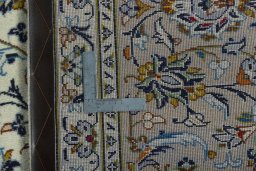 Backside of handmade 2000s Kashan rug showing knot structure and weave density