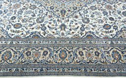 Corner detail of 2000s Kashan rug showing border pattern and Wool pile