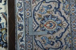 Backside of handmade 2000s Kashan rug showing knot structure and weave density