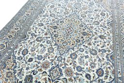 Backside of handmade 2000s Kashan rug showing knot structure and weave density