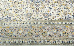 Corner detail of 2000s Kashan rug showing border pattern and Wool pile