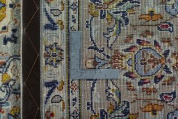 Backside of handmade 2000s Kashan rug showing knot structure and weave density