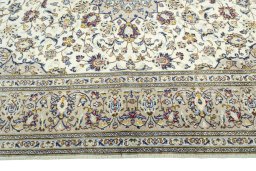 Corner detail of 2000s Kashan rug showing border pattern and Wool pile