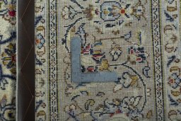 Backside of handmade 2000s Kashan rug showing knot structure and weave density