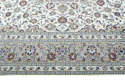 Corner detail of 2000s Kashan rug showing border pattern and Wool pile